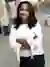 Headshot of Erica Rutherford with long black wavy hair, wearing a white blouse, standing outdoors with arms crossed.